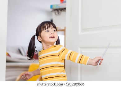 Asian Child Girl Playing At Home.Home School Kid Play Hide And Seek With Her Parents During Covid19 Lockdown.Happy Moment And Good Activity.Happy Loving Family.Asian Toddler Girl Child Playing Home 