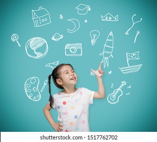 Asian child girl pointing at the blackboard with imagination the doodle art, Creative and dreams of childhood concept - Powered by Shutterstock