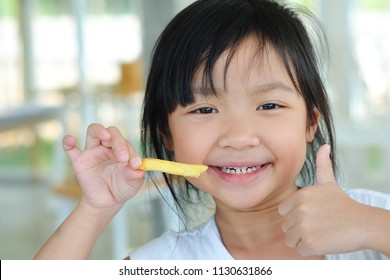 Asian Child Girl Show Thumb Up And Happy Eating French Fries