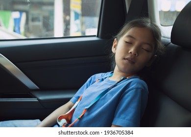 Asian Child Girl Is Sleeping In The Car While Traveling To School. Childhood And Family Lifestyles In Car Concept.