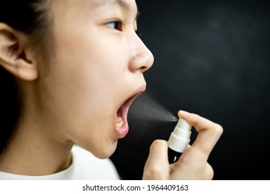 Asian Child Girl Spraying Medicine,treatment For Pain In Oral,sore Throat With Cold,flu,protect Against The Coronavirus COVID-19 In Throat,spray For Bad Smell From Mouth,symptoms Of Halitosis Disease