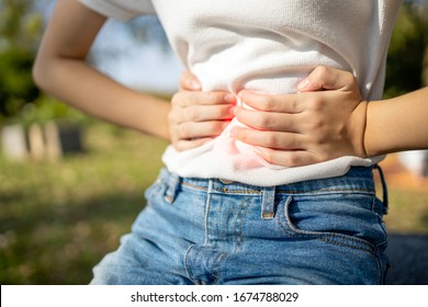 Asian Child Girl With Stomach Ache,woman Having Aching Belly With Stomach Flu Or Gastroenteritis Virus (norovirus Infection) Causes Of Gastritis,severe Pain,abdominal Problems,irritable Bowel Syndrome