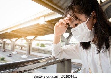 Asian Child Girl Suffer From Headache With The Weather Is Very Hot And Air Pollution,allergy To Dust, Feel Sick,dizzy,fainting, People Wearing Face Mask Protection Because Dirty Air Prevent PM 2.5