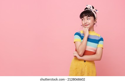 Asian child girl thinking something isolated on pink copy space background. - Shutterstock ID 2128068602