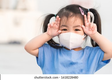 Asian child girl wearing a protection mask against PM 2.5 air pollution 2020 in Bangkok city. Thailand.