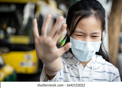 Asian Child Girl Wearing Protective Mask At Bus Stop In The  City,show Stop Gesture,hand