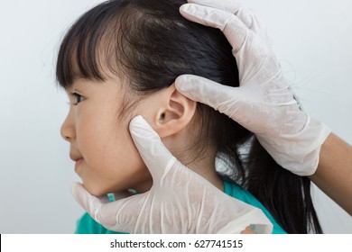 Asian Child Has Ear Check Up By Doctor