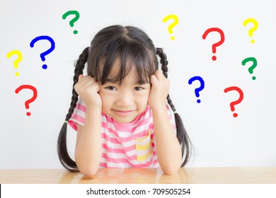 Asian Child Has A Headache With Colorful Question Marks On White Background