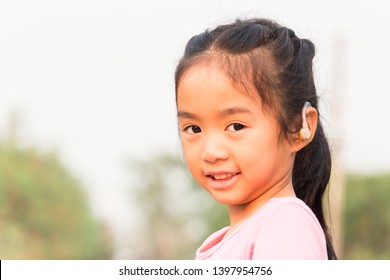 Asian Child With Hearing Aid Can Help Her  To Hear More Clearly