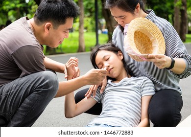 Asian Child With Heat Stroke,vertigo,dizziness,sick Daughter On A Sunny Day,cute Girl Having Exhausted Suffering From Sunburn Very Hot In Summer .