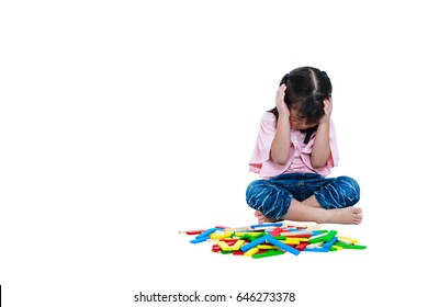 Asian Child Hold The Head With Hand While Play Toy Wood Blocks. Sad Girl Crying And Showing Moody Behavior. Isolated On White Background. Educational Toys For Kindergarten Child. Free Form Copy Space.