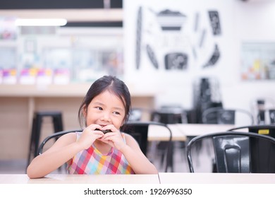 Asian Child Hungry Or Kid Girl Enjoy Eating Rice Ball Seaweed Roll To Japanese Food And Appetizing On Table And Happy For Breakfast Or Lunch In Restaurant Or Food Court And Canteen Kitchen At School