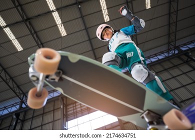 Asian Child Or Kid Girl Playing Skateboard Or Surf Skate And Fun Ollie Jumping Or Drop Start On Bowl In Skate Park By Extreme Sports To Wearing Helmet Elbow Pads Wrist And Knee Support For Body Safety