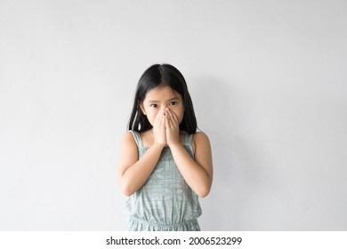 Asian Child Or Kid Girl Sick And Sneezing Or Cold Cough With Hand Close Mouth And Nose To Influenza From Virus Bacteria Or Dust And Allergy With Bad Smell On Preschool For Medical And White Background