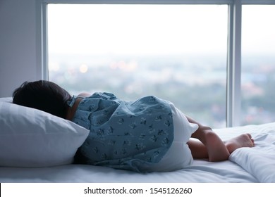 Asian Child Or Kid Girl Sleeping Alone And Lonely Depress Or Comfortably And Sweet Dream For Relax On White Bed And Pillow In Bedroom At Home With Morning Cool Light On Window And Wake Up Late