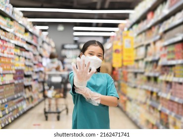 Asian Child Or Kid Girl Wearing Face Mask And Person Show Or Present Plastic Gloves For Shopping In Supermarket Mall Or Department Store For Clean And Safety To Protect Coronavirus Covid-19 Disease