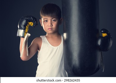 Asian child nearly the heavy bag on vintage