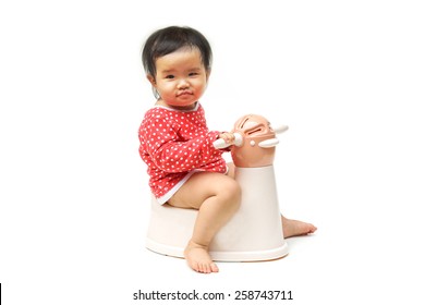 Asian Child On Potty Play - Learning To Use Toilet