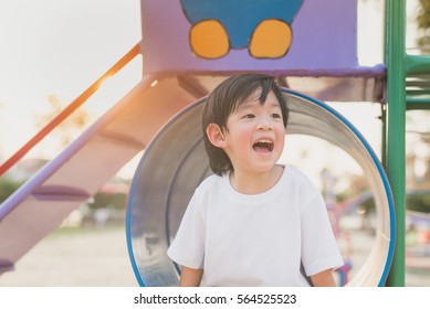 Asian Child Playing On Playground In Outdoor Park