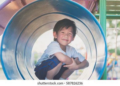 Asian Child Playing On Playground In Outdoor Park