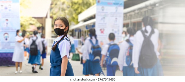 Asian Child In School Uniform Wearing Face Mask With School Bag And Social Distancing Protect From Coronavirus. Back To School For New Normal Lifestyle Concept. Panoramic Banner With Copy Space