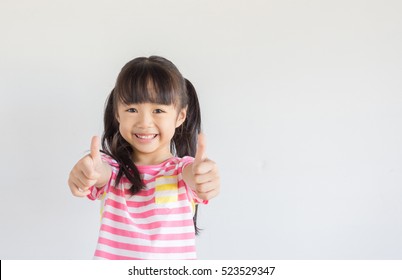 Asian Child Show Her Thumbs To Cheer Up With Happily