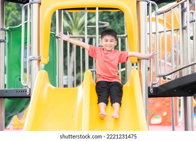 Asian child smiling playing on slider bar toy outdoor playground, happy preschool little kid having funny while playing on the playground equipment in the daytime in summer, Little boy climbing - Powered by Shutterstock