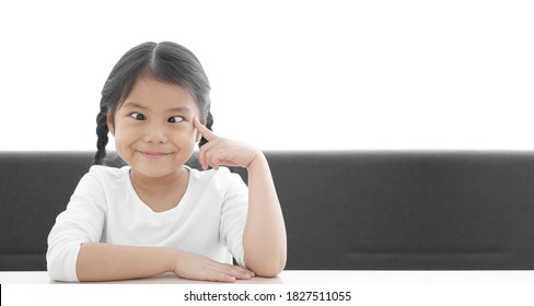 Asian Child Strabismus Or Kid Girl Squint Lazy Eye And Amblyopia With Finger Point Eye Or Brain Head For Think To Lasik Eye Surgery Technology With Smile Happy At Nursery Pre School On White Space