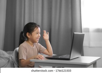 Asian Child Student Or Kid Girl Smile Enjoy And Make Hand Ok On Computer Notebook For Communication And Study Online Or Learn From Home To Play Laptop For Education School By Stay Safe In Bedroom