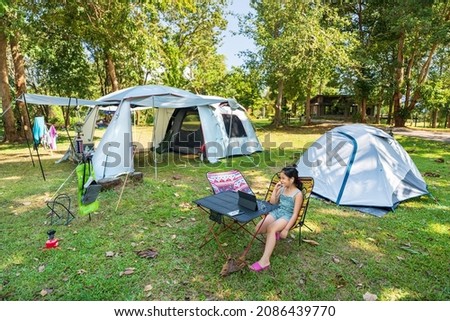 Similar – Women resting and talking lying in tent over car