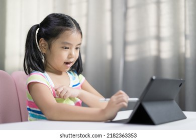 Asian Child Student Studying Online Class On Computer Or Kid Girl Enjoy Fun Writing Or Art Drawing By Touch Pen On Tablet Screen To Video Call Learning Write Or Person Happy Learn From Home School
