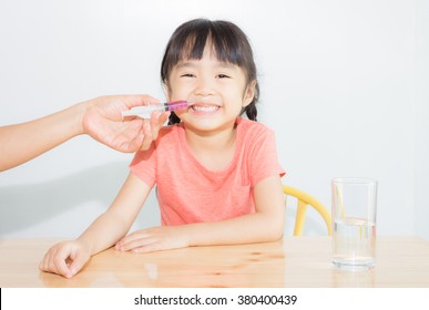 Asian Child Take Medicine By The Syringe