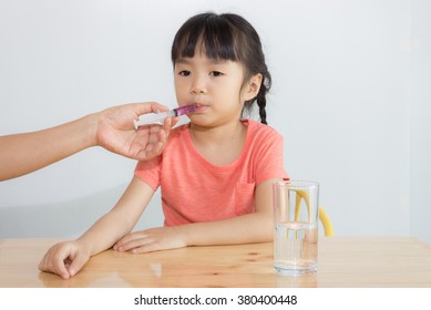 Asian Child Take Medicine By The Syringe