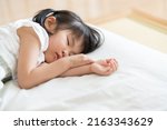 Asian child taking a nap