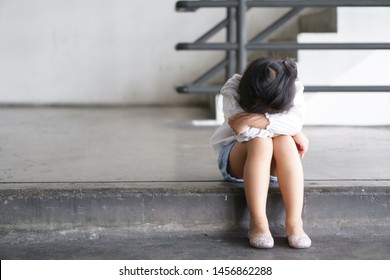 Asian Child Touchy Or Kid Girl Sleeping And Angry Cry With Sad Or Have Problems And Bend Down The Head Lonely To Wait For The Parents On City Street At Nursery Or Kindergarten And Pre School