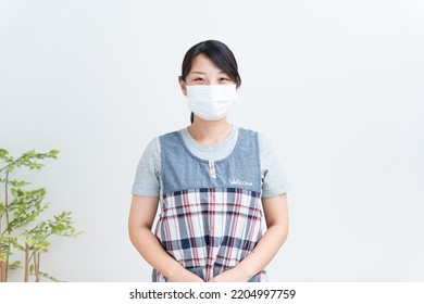 Asian Childcare Worker Wearing A Mask