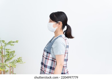 Asian Childcare Worker Wearing A Mask