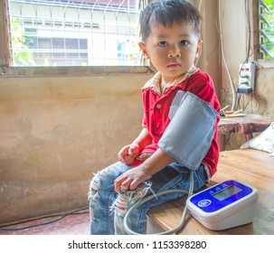 Asian Children Cute Or Kid Boy Health Check With Blood Pressure Gauge At Rustic Home