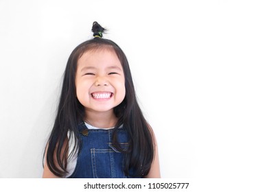 Asian Children Cute Or Kid Girl And Kindergarten Student Happy Smile White Teeth And Laugh With Wear Dungarees Jean For Fashion Or Child Dental On White Background With Space Isolated