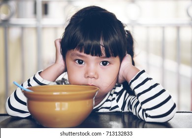 Asian Children Cute Or Kid Girl Student Anorexia Or Sad With Vacant And Prop Up Or Hand To Cheek On Food Table For Breakfast Before Going To School For Study On Vintage Style