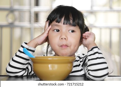 Asian Children Cute Or Kid Girl Student Anorexia Or Sad And Holding Food In Mouth With Vacant And Prop Up Or Hand To Cheek On Food Table For Breakfast Before Going To School For Study