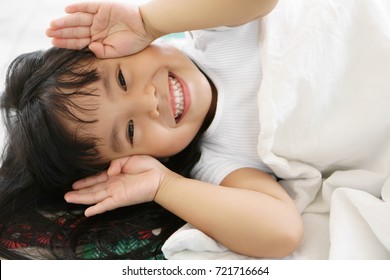 Asian Children Cute Or Kid Girl Sleep With Open Hand From Eye For Enjoy Playing Peekaboo Or Hide And Seek With Smile White Teeth