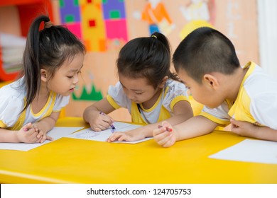 Asian Children Are Drawing In The Room