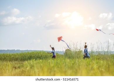 Asian children farmer  flying a kite in the rice field.
