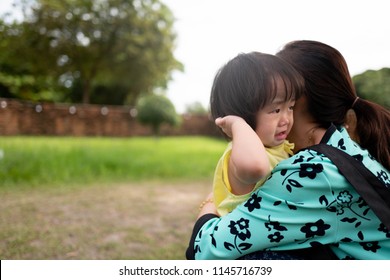 Asian Children Feel Sad To Hug Mother In The Garden.