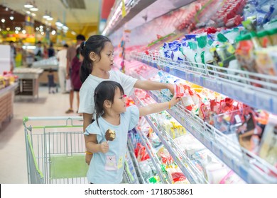 Asian Children Girl Shopping With Choose To See Fresh Food In Department Store.