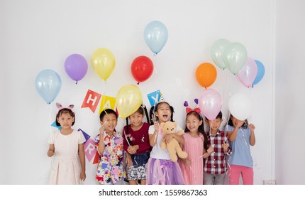 Asian Children Group Playing Helium Balloon In Birthday Party,