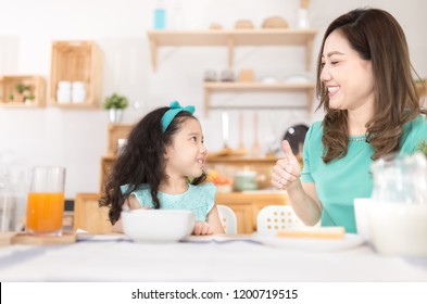 Asian Children And Her Mom Have A Breakfast In The Morning, Asian Mother Feeling Glad And Show Thumbs Up Sign With Her Hand, Child Nutrition And Development, They Feeling Happy In Family Time