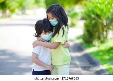 Asian Children With Mask.People With Facemask.Little Boy And Girl With Masks In Outdoor.Hugging Kids.Stop Racism.Flu And Influenza Protection.Covid19 And Corona Virus Health Care.