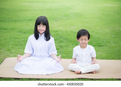 Asian Children Meditating In Lotus Position